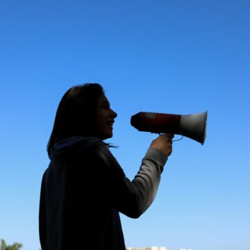 Person speaking into megaphone